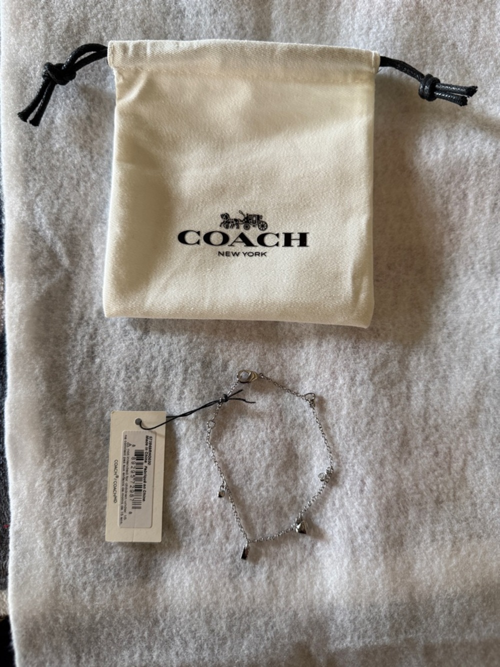 Coach Silver-Tone Charm Bracelet with Cream Drawstring Pouch